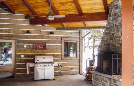 outdoor kitchen with grill and fireplace